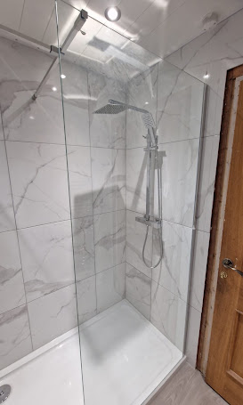 Glass shower enclosure with marble-effect tiling