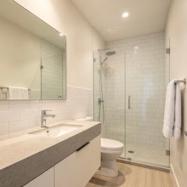 Bathroom with wide mirror and glass shower