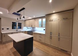 Grey shaker kitchen with dark island and pendant lights