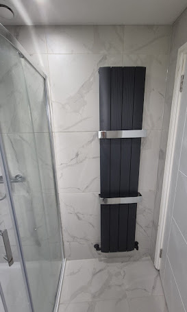 Marble-effect shower with black heated towel rail