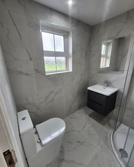 Grey marble-effect shower room with dark vanity
